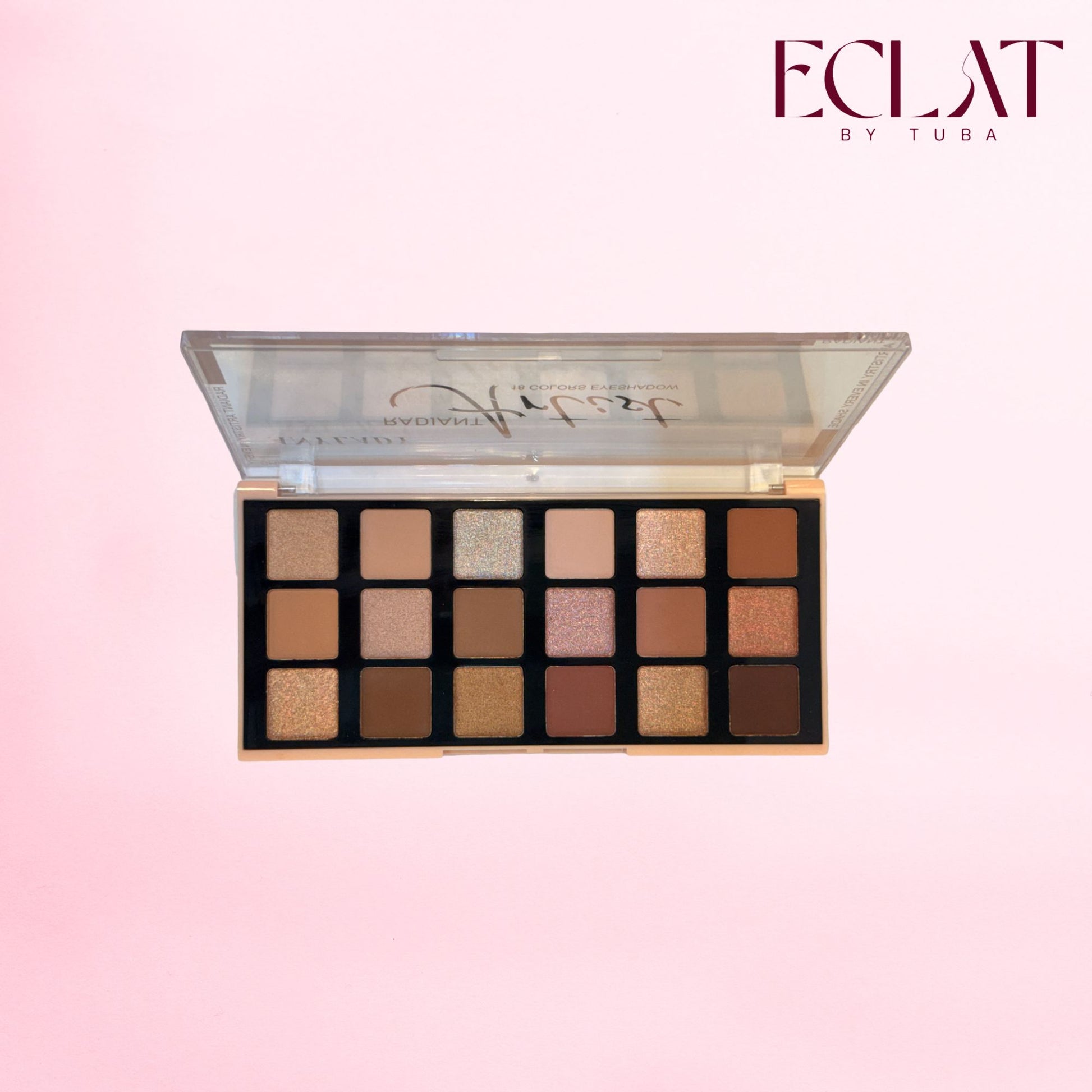 An open eyeshadow palette with 16 square pans in neutral shades, shown against a soft pink gradient background. The brand name 'ECLAT BY TUBA' is visible in the top right corner.